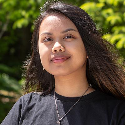 A smiling young woman with long hair.