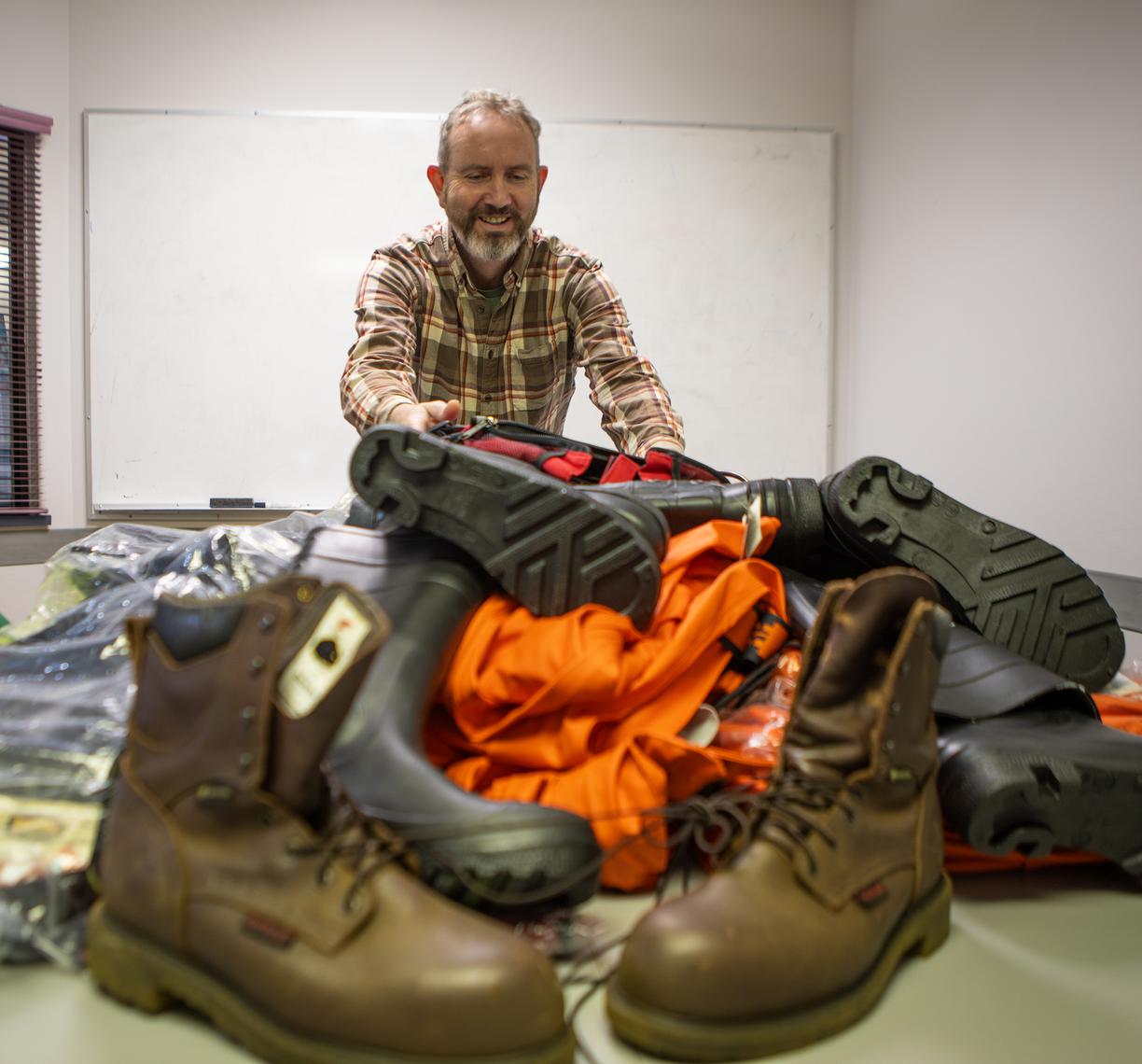 Mike L with gear in the gear closet